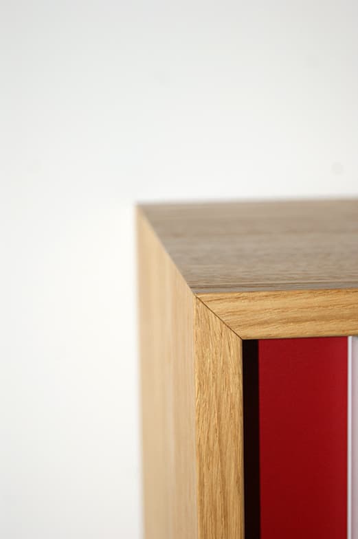 Detail einer hellen Holzplatte mit roter Schrankfront in der Steuerkanzlei Hoinle